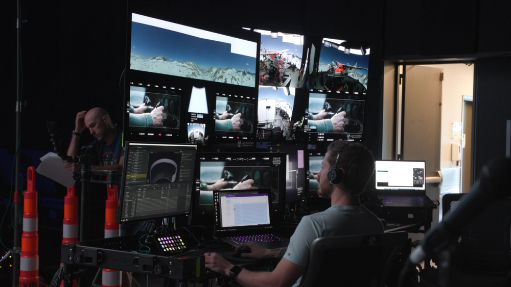 A crewperson monitors the volume system and camera frame